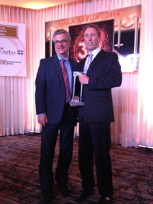 Jean-François Albert, vice-president of manufacturing at Mega Brands, accepts the Tribute Award from minister and member of the National Assembly for Saint-Laurent, Jean-Marc Fournier, at the 30th Alpha 2014 Gala on May 15.