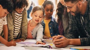 A teacher works with students.